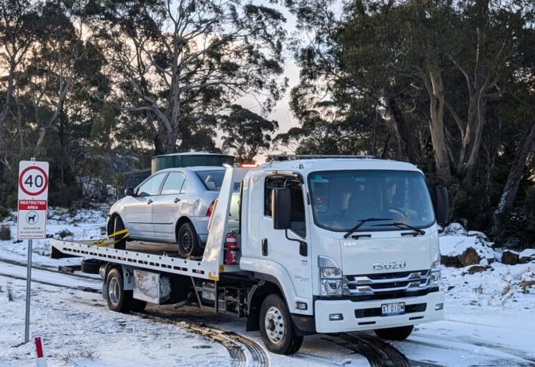 A white Isuzu Tow Truck owned by Big Boy Towing