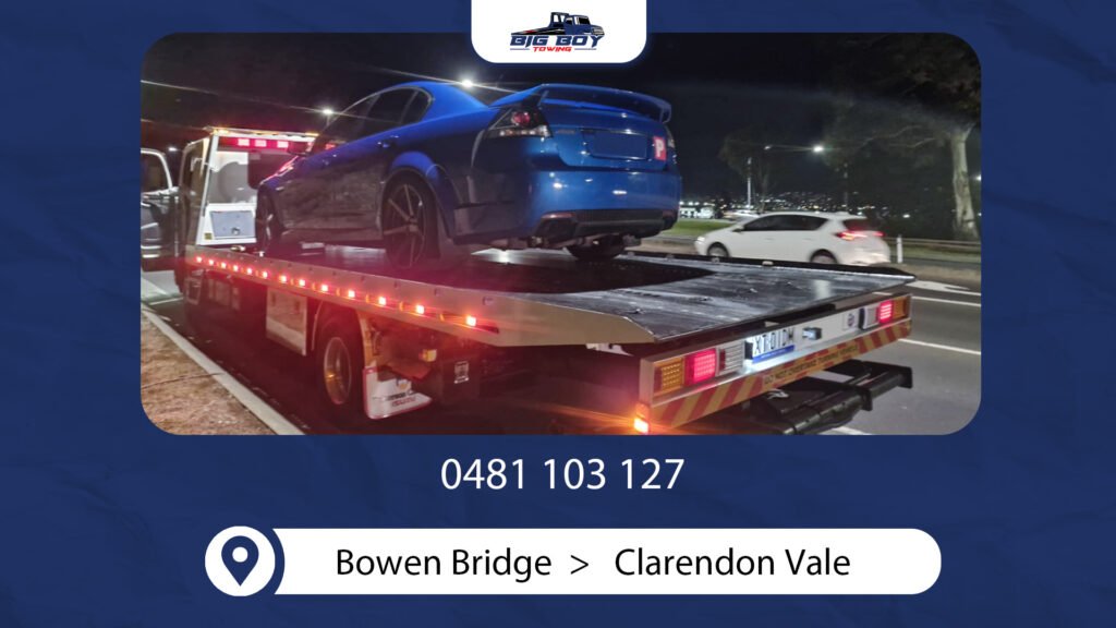 Big Boy Towing towing a car at night from Bowen Bridge to Clarendon Vale area
