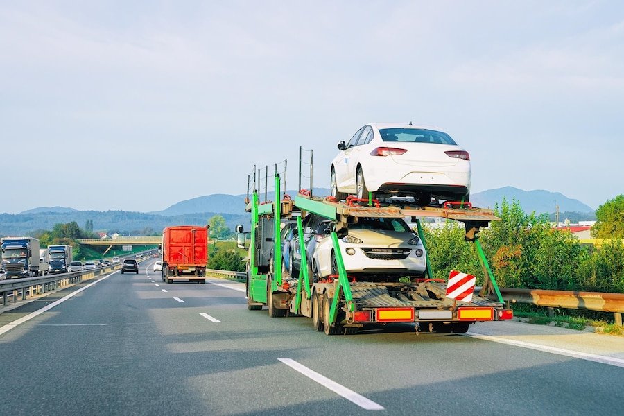 Hobart to Launceston car transport truck carrying a vehicle on the highway