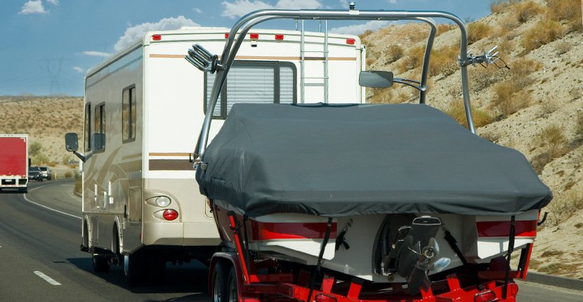 Boat towing Hobart service moving a large vessel on a trailer.