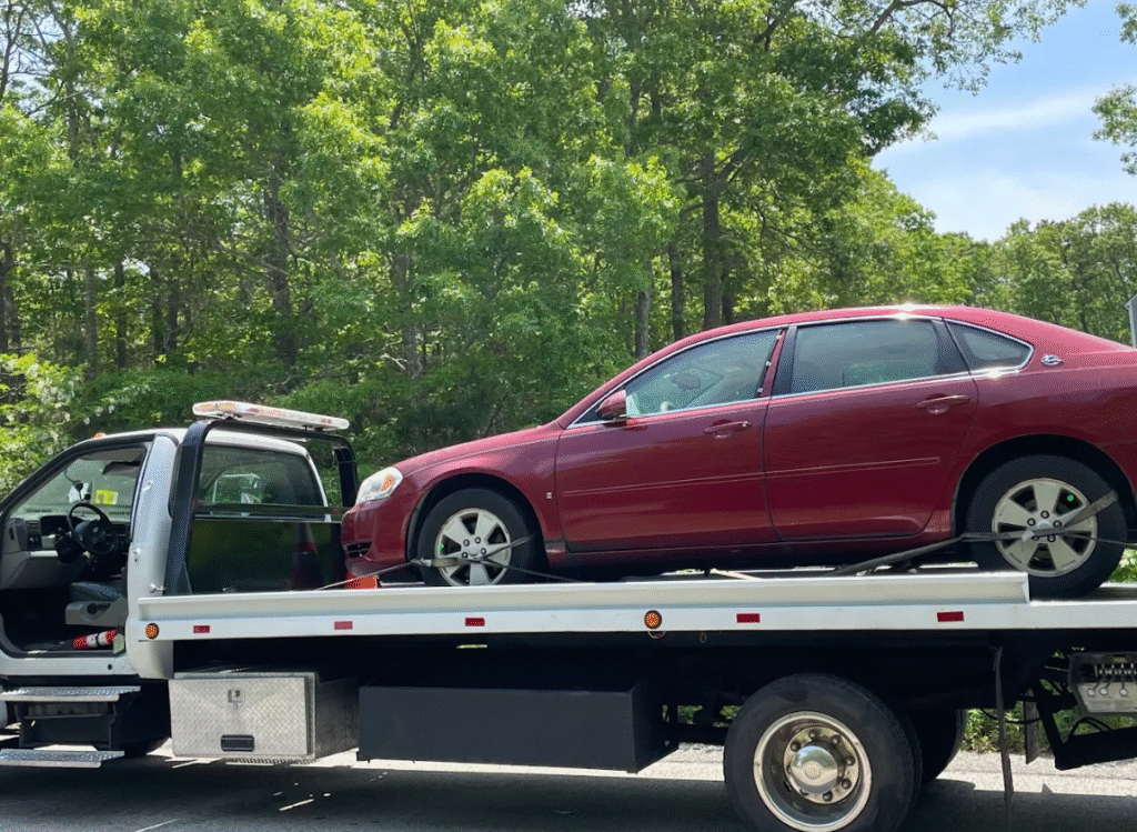 Future of towing Tasmania showing an electric vehicle being loaded onto a modern tow truck.